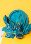 turquoise shoes and props on yellow background
