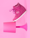 pink shoe leaning on pink lamp